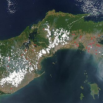 A satellite image showing the location of the Panama Canal: dense jungles are visible in green, topped by clouds