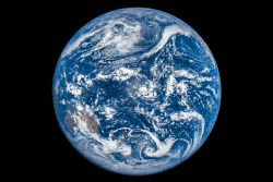 From space, the Moon's shadow during the solar eclipse of March 9, 2016 appears as a dark spot moving across Earth.