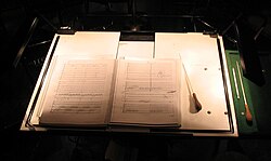 A conductor's score and baton