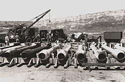Long, tube-like casings. In the background are several ovoid casings and a tow truck.
