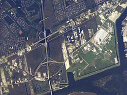 A section of eastern New Orleans after Hurricane Katrina. The Michoud Assembly Facility (MAF) at right (green) is not flooded, while the surrounding neighborhoods (dark greenish brown) are extensively flooded.