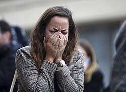 A woman crying and covering her face