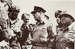 MacArthur confers with Lieutenant General Walton Walker (right) and other soldiers of the Eighth Army in July 1950.