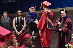 A post-secondary graduate receives a diploma during a graduation ceremony at Germanna Community College in Virginia.