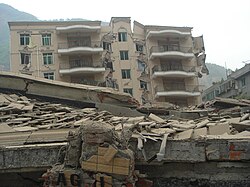 A bank building in Beichuan after the earthquake. A girl was found alive in the ruins 102 hours (4 days, 6 hours) after the earthquake.[66]