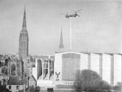 A helicopter placing the Flèche (spire) on top of the new Coventry Cathedral in 1962
