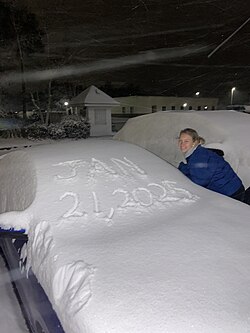 A resident next to a snow-covered car in Niceville, Florida