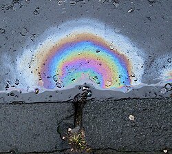Diesel does not mix with water. This picture also showcases the phenomenon of thin-film interference.