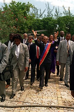 Jean-Bertrand Aristide returns to Haiti following the U.S.-led invasion in 1994 designed to remove the regime installed by the 1991 Haitian coup d'état