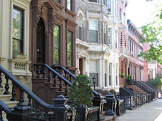Landmark 19th-century rowhouses on tree-lined Kent Street, in Greenpoint Historic District