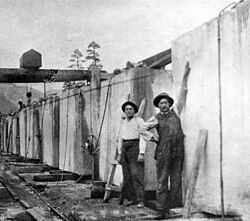 April 1914 – June 1916:marble blocks for Lincoln Memorial column sections (aka drums) at 8.333 feet (2.540 m) x 8.333 feet (2.540 m) x 4.5 feet (1.4 m) weighing 26.25 tons (26.18 metric tons) each. The man on the left is Henry Johnson, the photographer for the Colorado-Yule Marble Company.