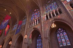 The interior south wall of the nave. James Madison is shown in brown and royal blue in the rightmost panel of the upper right window.