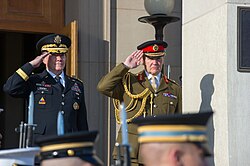 Houghton (right) taking the salute alongside his American counterpart in 2013