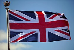 A Union Jack flying from a jackstaff onboard a Royal Navy warship, 2011