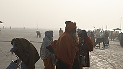Priests taking dip in Ganges, a river considered holy in Hinduism as a part of ritual purification