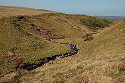 Dobbingstone Burn, Scotland, showing two different types of erosion affecting the same place. Valley erosion is occurring due to the flow of the stream, and the boulders and stones (and much of the soil) that are lying on the stream's banks are glacial till that was left behind as ice age glaciers flowed over the terrain.