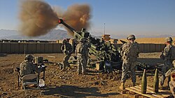 7-person gun crew firing a US M777 Light Towed Howitzer, War in Afghanistan, 2009