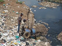 Siltation caused by fecal sludge collected from pit latrines and dumped into a river at the Korogocho slum in Nairobi, Kenya.