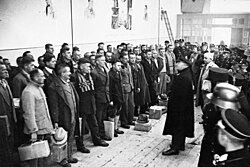 The camp commander gives a speech to prisoners about to be released as part of a pardoning action near Christmas 1933.