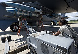 Members of the Global Strike Challenge nuclear/conventional load crew team lift a GBU-31 Joint Direct Attack Munition into position during a dry run leading up to the 2012 Air Force Global Strike Command Challenge on Barksdale Air Force Base, Louisiana, 20 Aug 2012