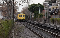 Line B rolling stock running aboveground on the Urquiza Line