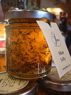A jar of mint jelly, a traditional condiment served with lamb dishes