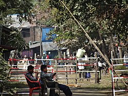 Police checkpoint next to Aung Mingalar in Sittwe with closed-off Rohingya Muslim area in the background.