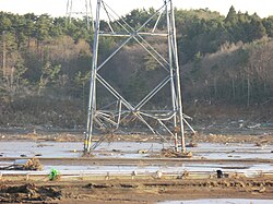 A damaged transmission tower and severed power lines in Minamisōma, Fukushima