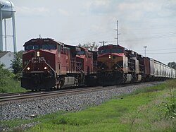 Two CPKC unit trains, one grain and another crude oil, meet up at Siloam Springs, Arkansas, with locomotives from each of the two preceding railroads.