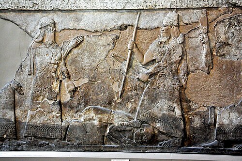 A relief from Nimrud depicting Tiglath-Pileser (right) trampling a defeated enemy