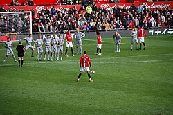 Cristiano Ronaldo preparing to take a free kick in a 2009 match between Manchester United and Liverpool