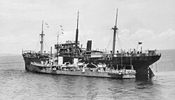 Tenedos, 3 February 1942, alongside a damaged merchantman in the Bangka Strait. Note her reconfigured stern, which had been altered for minelaying.