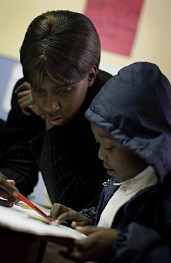 Mercy Mehlomakulu, a teacher who has come from Zimbabwe in search of work and who has recently prequalified in South Africa with assistance from AusAid, teaches some of her pupils in St Albert's school which is part of the Methodist Mission, Johannesburg, South Africa on 4 June 2009.