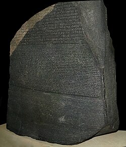 The Rosetta Stone, a trilingual decree recording the 196 BC coronation of Ptolemy V at Memphis in Egypt.