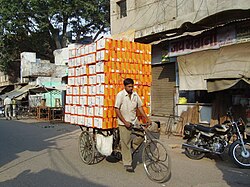 A cycle rickshaw carrying shoe boxes in Agra