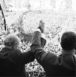 Quwatli clasps hands with Nasser before crowds of spectators in Damascus days after the United Arab Republic is established, March 1958