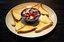 A swordfish hinava served with sandwich bread