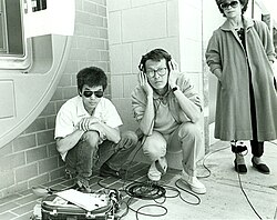 Sound recordist Curtis Choy (left) on location for Dim Sum: A Little Bit of Heart, an indie film by director Wayne Wang (center) on Clement Street in the Richmond District of San Francisco, California 1983