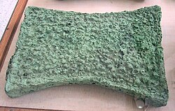 An oxhide ingot from Crete. Late Bronze Age metal ingots were given standard shapes, such as the shape of an "ox-hide", suggesting that they represented standardized values.