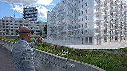 An example of augmented reality: A man viewing a life-size virtual model of a building