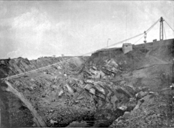 A blondin at Stoney Stanton quarry, showing the cableway crossing a deep pit. At the top right a wagon is suspended from the cradle, ready to be lowered to the quarry floor
