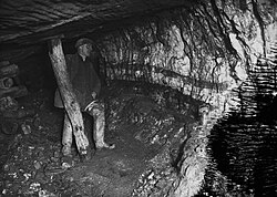 A miner underground at Pumsaint gold mine, Wales; c. 1938.