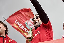 Klopp celebrating Liverpool winning the domestic cup double in a trophy parade in 2022