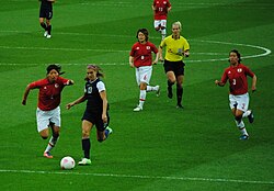 Morgan challenges Japanese defender Saki Kumagai for the ball as Mizuho Sakaguchi (6) and Azusa Iwashimizu (3) look on during their gold medal match at the 2012 Summer Olympics.