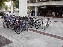 A busy bike and ride rack at Brickell station. Some stations have bike lockers; bicycles are also allowed on the trains.[53]