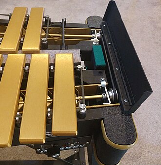 The exposed mechanism of the motor and rubber pulley is shown.