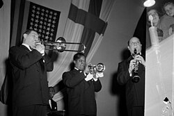 With Jack Teagarden (left) and Barney Bigard (right), Armstrong plays the trumpet in Helsinki, Finland, October 1949