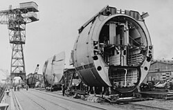 A prefabricated segment of a Type XXI U-boat. The cross-section shows clearly the '8'-shaped hull, where the lower part was used to store large batteries hence the name of 'ElektroBoot'