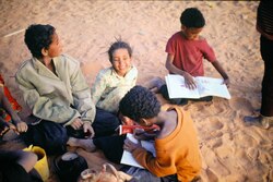 1991: Nomadic children doing homework. Oued Samene, southeast Algeria