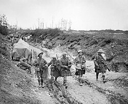 A piper of the Seaforth Highlanders leads the 26th Brigade back from the trenches during the Battle of Bazentin Ridge, July 1916
